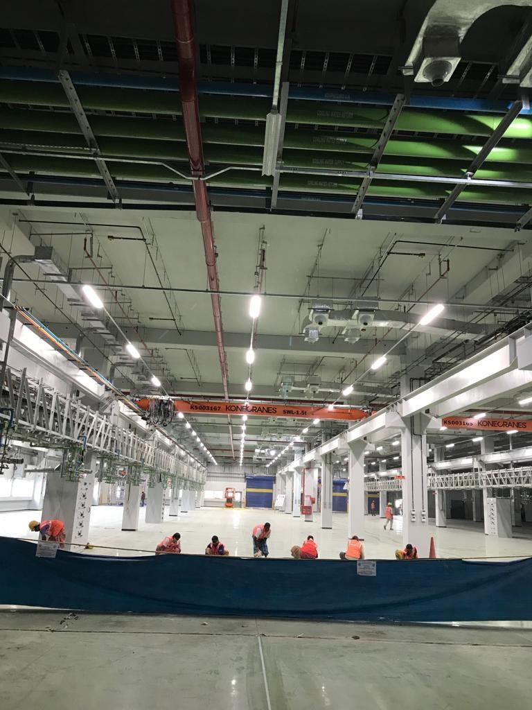 Industrial ducting and overhead crane installation inside a large warehouse facility